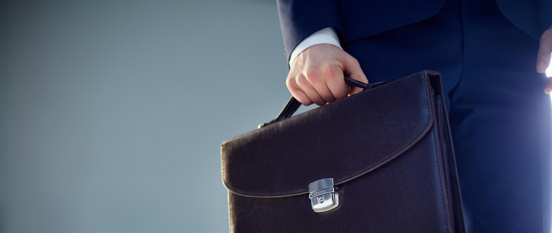 Isolated image of a businessman carrying a briefcase 
