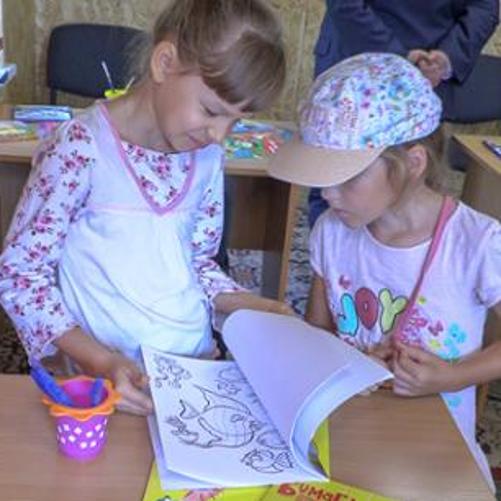 Girls are looking into a book