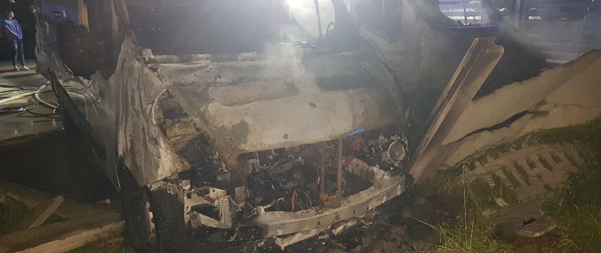 Na zdjęciu widzimy dwa spalone samochody. Pora nocna.