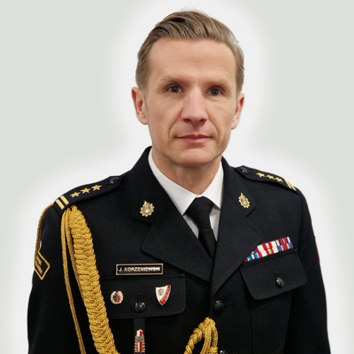 Zdjęcie przedstawia st. bryg. Jarosława Korzeniewskiego Zastępce Lubuskiego Komendanta Wojewódzkiego PSP w Gorzowie Wlkp. w mundurze na szarym tle.