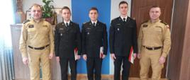Zdjęcie przedstawia strażaków stojących podczas wręczenia decyzji mianowania na stanowisko dowódcy zastępu