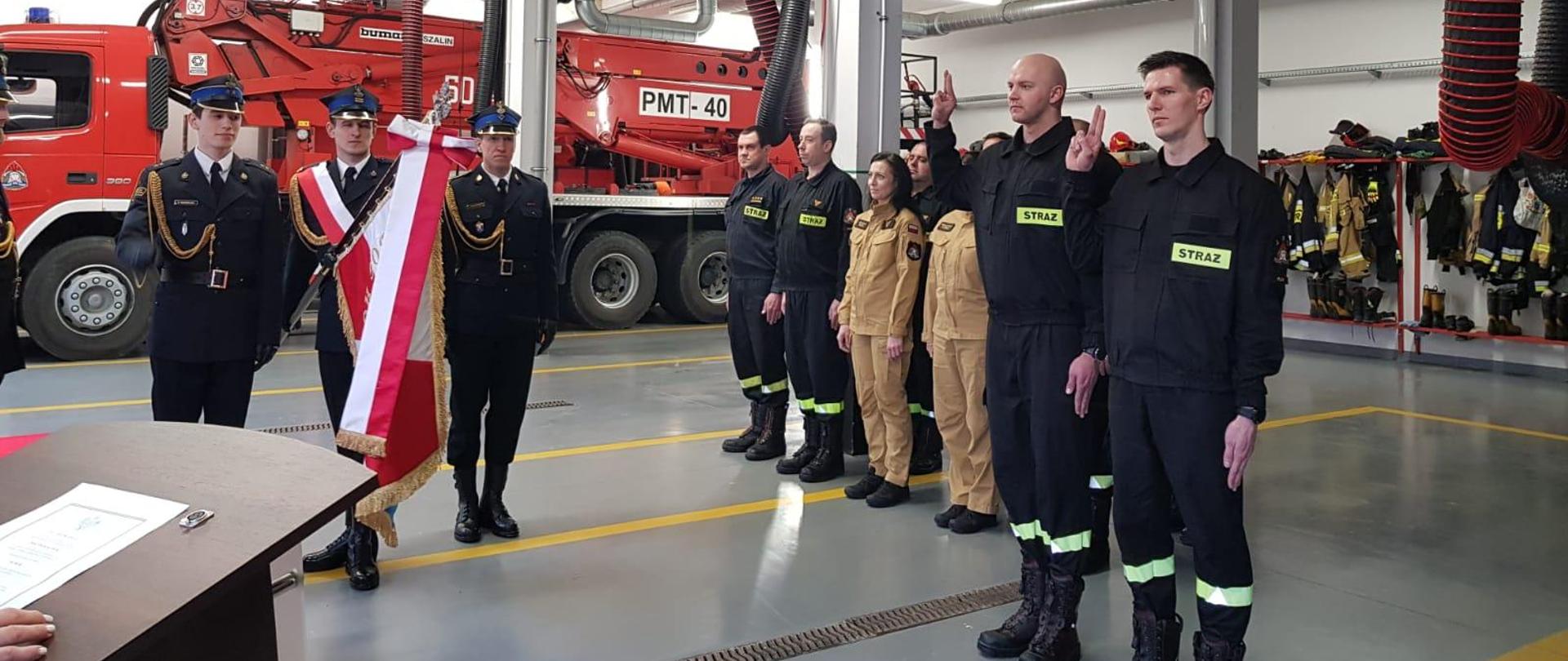 Na zdjęciu widać sztandar komendy w Pucku oraz strażaków, którzy przystąpili do ślubowania. W tle strażacy z komendy.