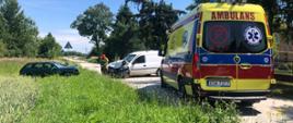 Na zdjęciu widać wypadek dwóch samochodów osobowych oraz strażaków podczas działań ratowniczych, na drugim planie Karetka Pogotowia Ratunkowego.