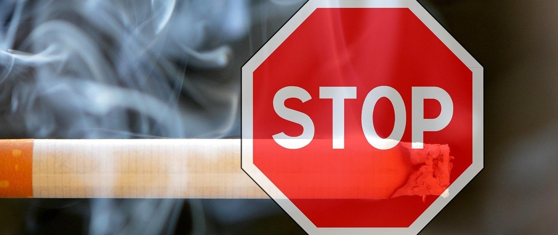 Palący się tradycyjny papieros, a na nim znak zakazu "Stop"