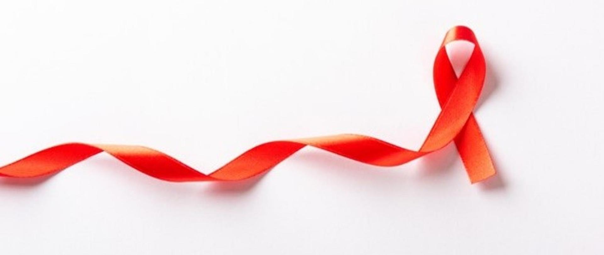 Symbol osób chorych na HIV - wstążka ciągnąca się od lewej do prawej. Kończy się pętlą