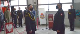 Na zdjęciu widzimy Komendanta Wojewódzkiego PSP i Komendanta Miejskiego PSP. Komendanci zwróceni są do siebie twarzą w tle widoczni zaproszeni goście i przedstawiciele służb mundurowych.
