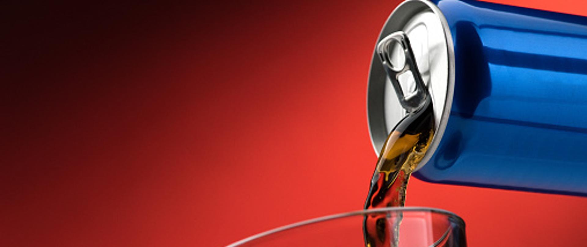 Pouring a refreshing sugary soft drink from a can into a glass