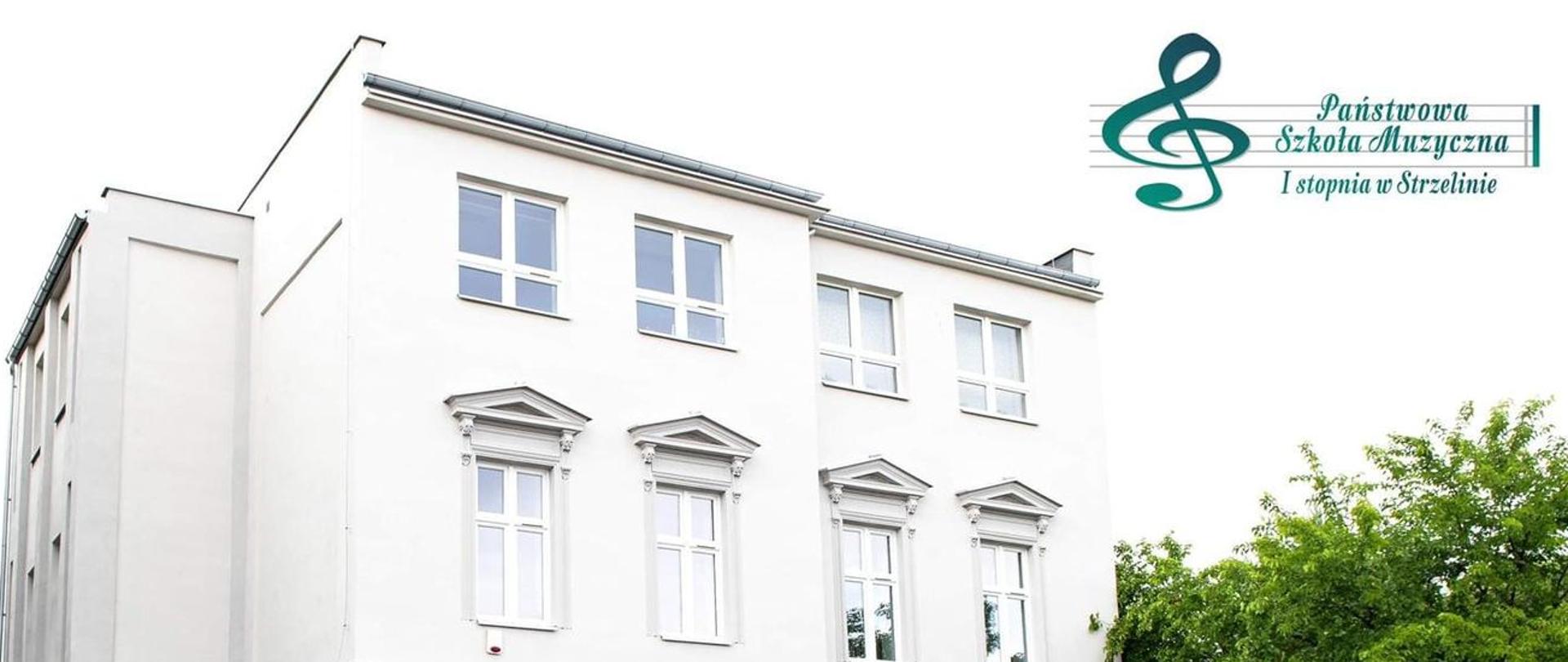 Na zdjęciu znajduje się budynek PSM Strzelin po termomodernizacji widziany od strony ulicy Jana Pawła II. W górnej części znajduje się logo PSM Strzelin.