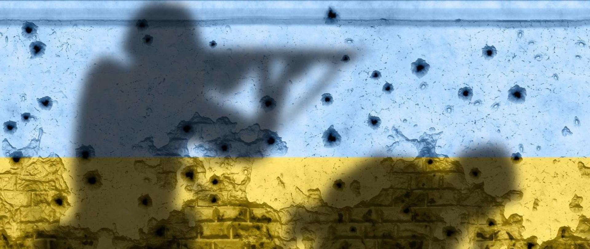 Żołnierze na tle muru w barwach Ukrainy