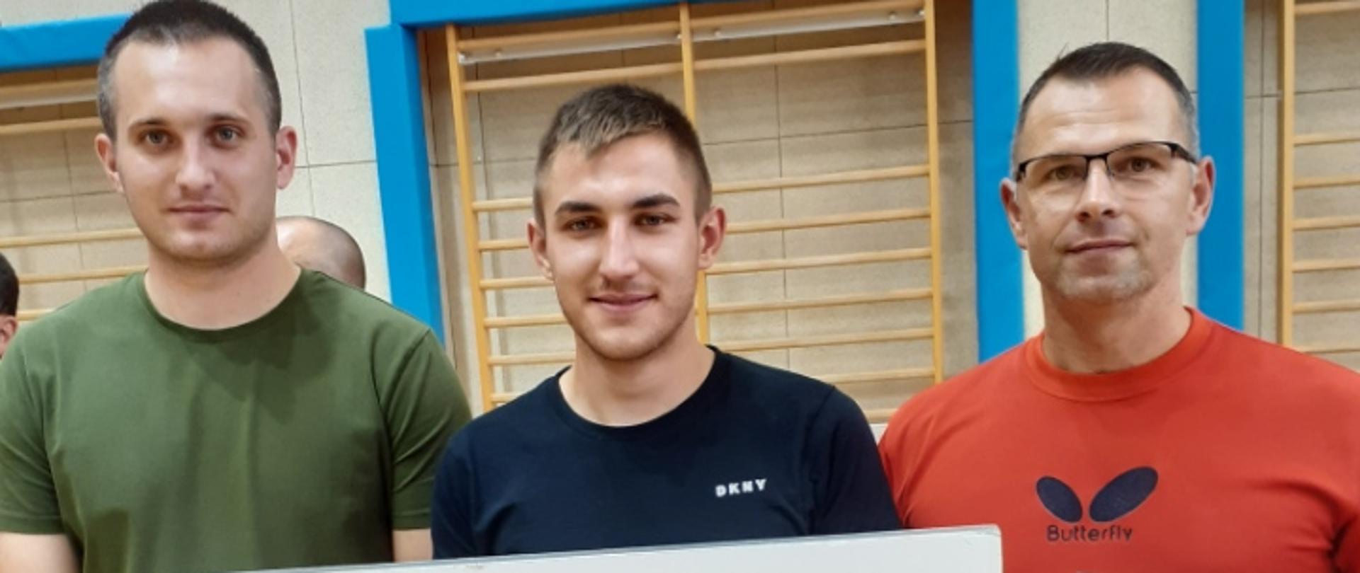 Trzech graczy pozuje do zdjęcia.