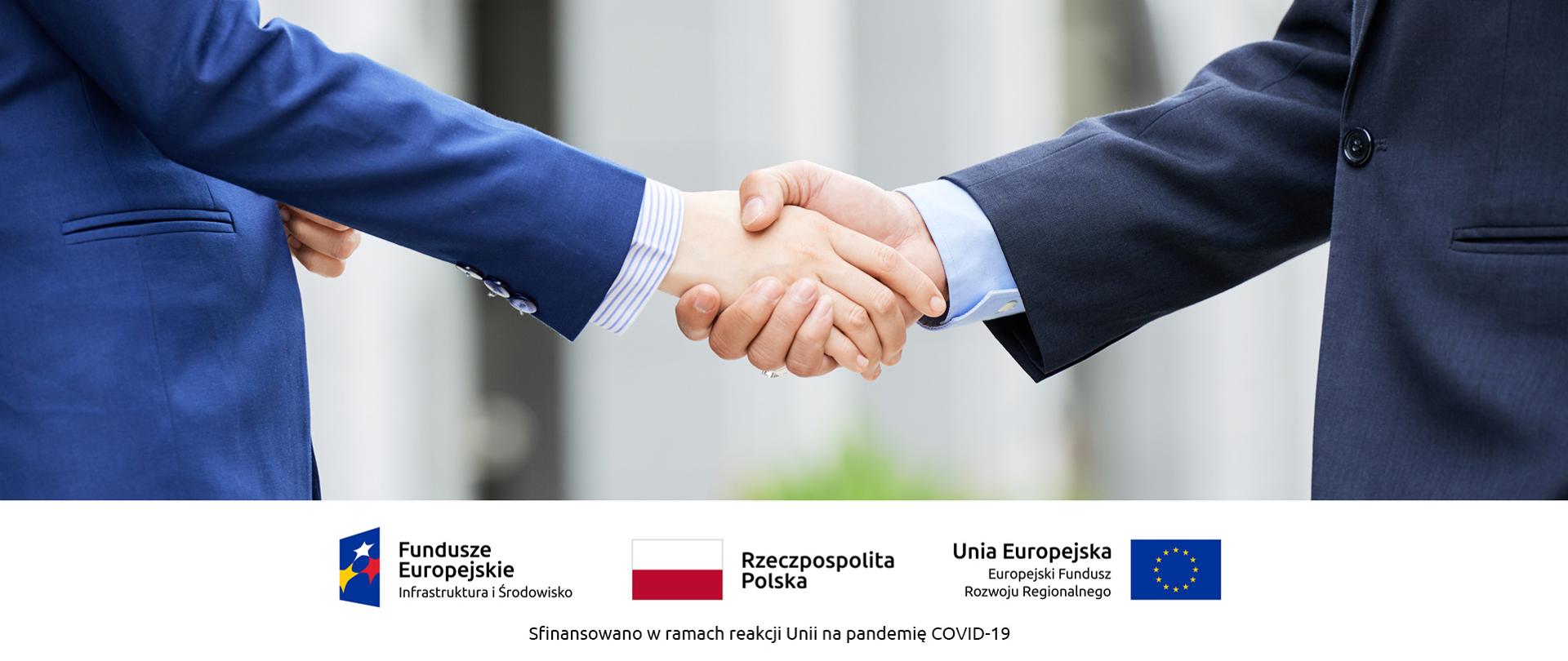 Banner przedstawiający dwie osoby ściskające sobie ręce. Pod spodem loga: Fundusze Europejskie Infrastruktura i Środowisko, Rzeczypospolita Polska, Unia Europejska Europejski Fundusz Rozwoju Regionalnego. Napis: Sfinansowano w ramach reakcji Unii na pandemię COVID-19.