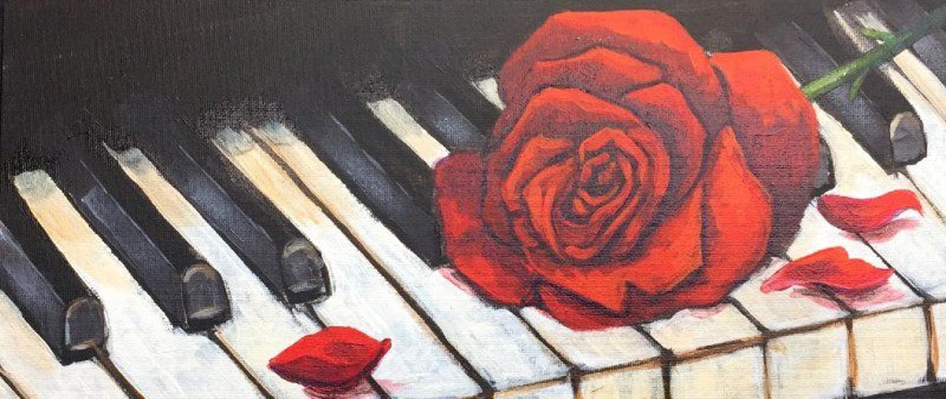 Zdjęcie przedstawiające obraz klawiatury z czerwoną różą