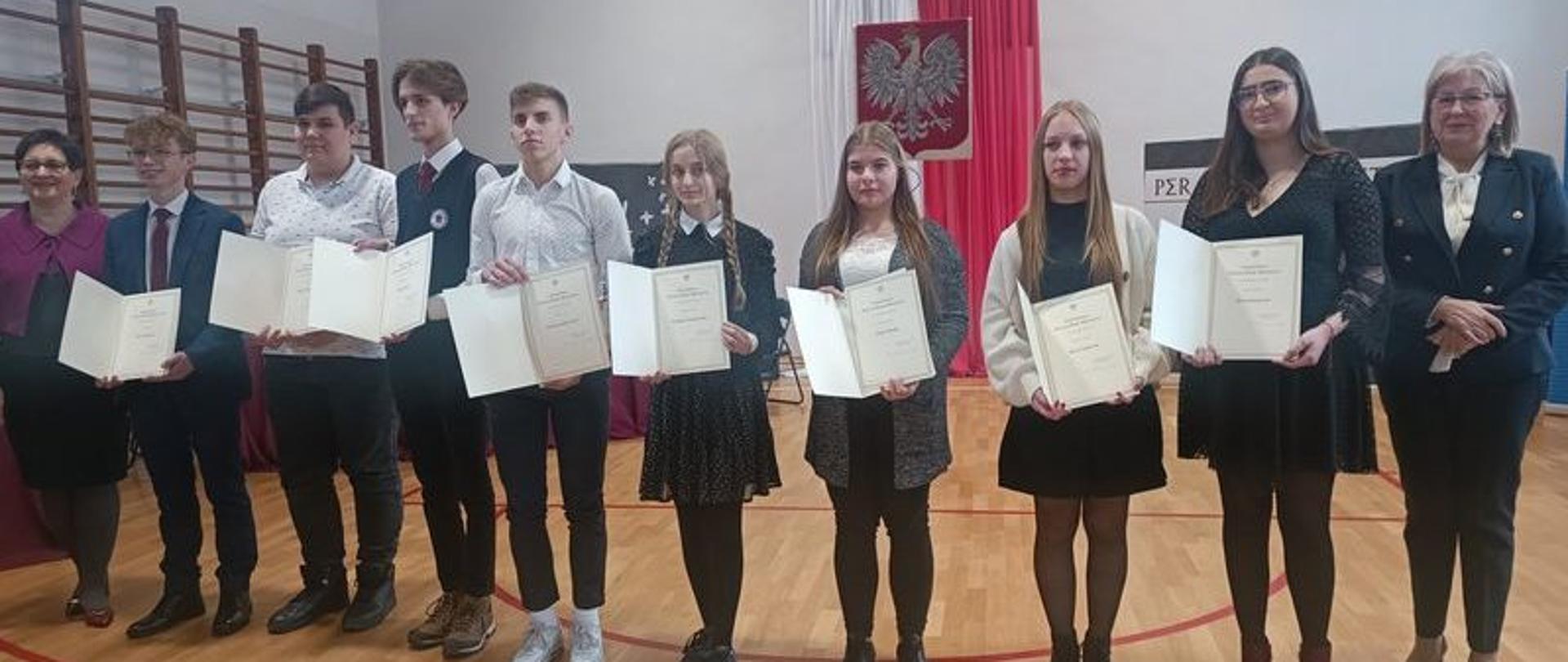 Na zdjęciu grupa uczniów trzymających w rękach dyplomy