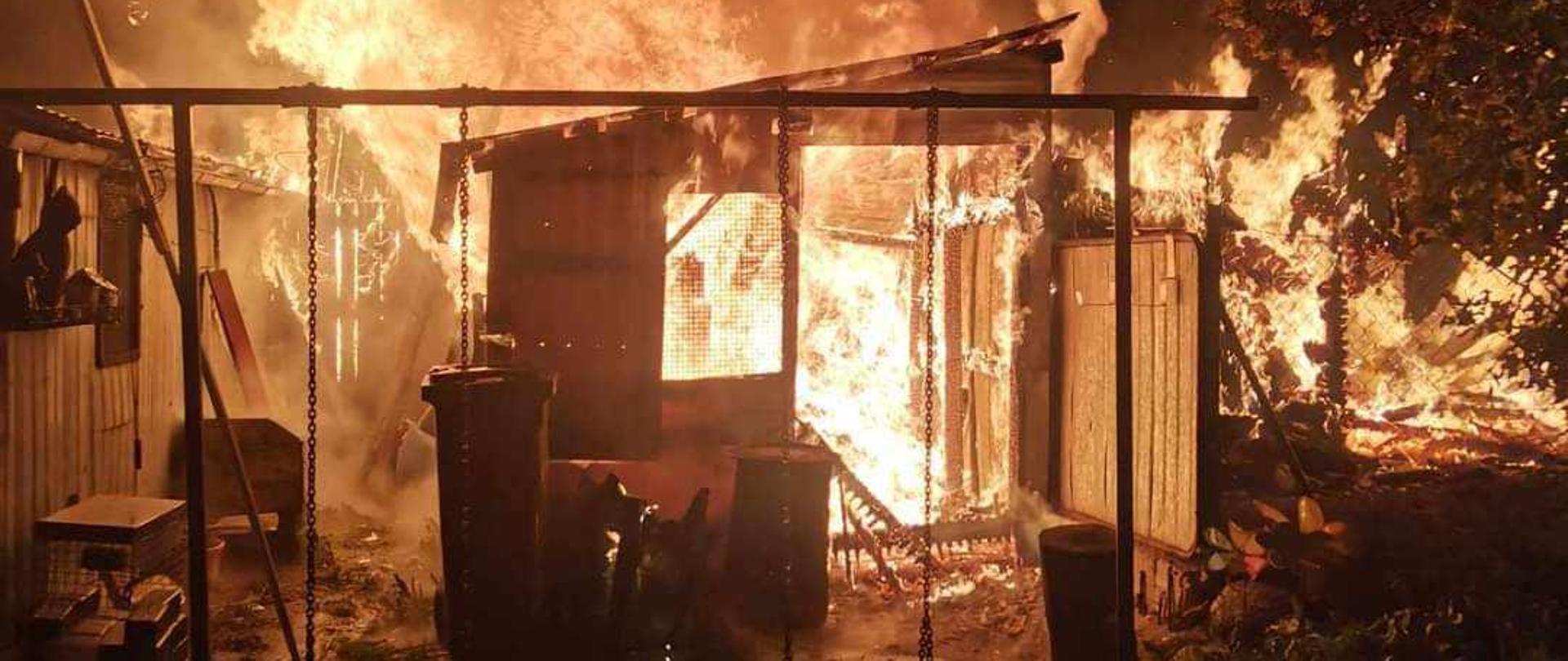 Zdjęcie przedstawia budynki gospodarcze w całości objęte ogniem