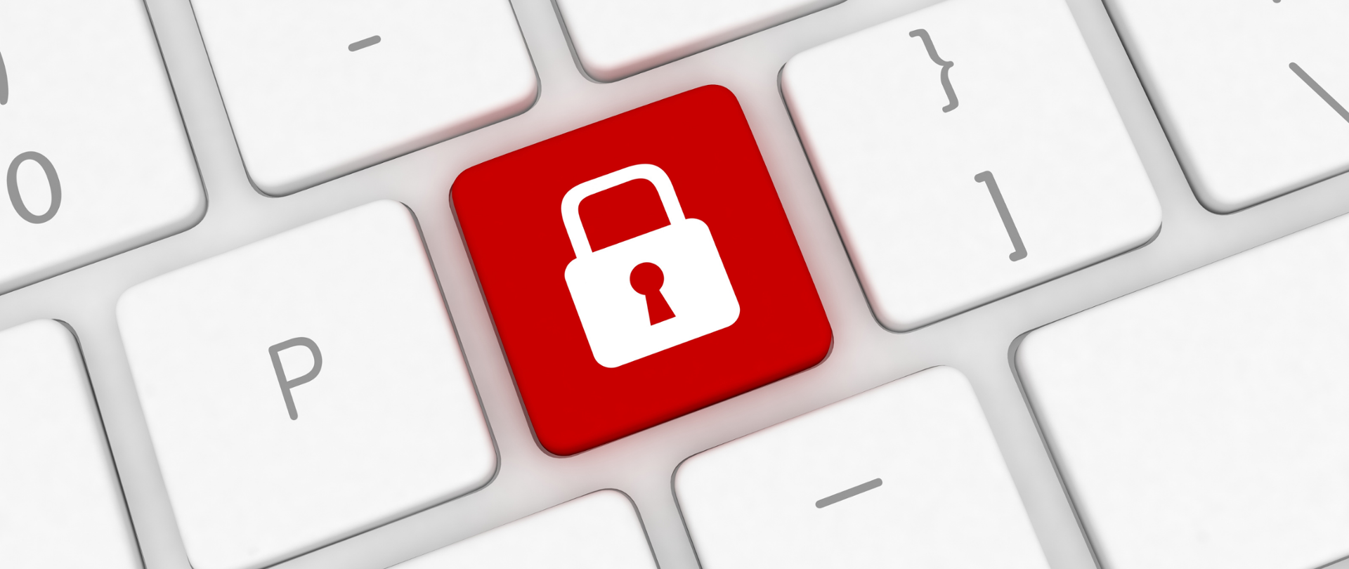 Biała klawiatura komputerowa, na środku widoczny czerwony przycisk z białym symbolem kłódki.