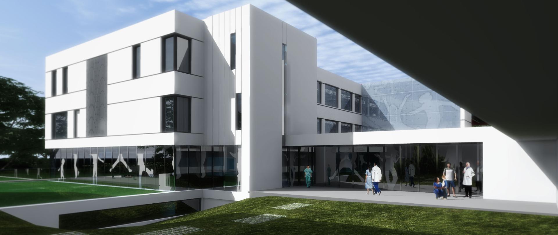 biału budynek z dużą ilością okien, przed budynkiem trawa 