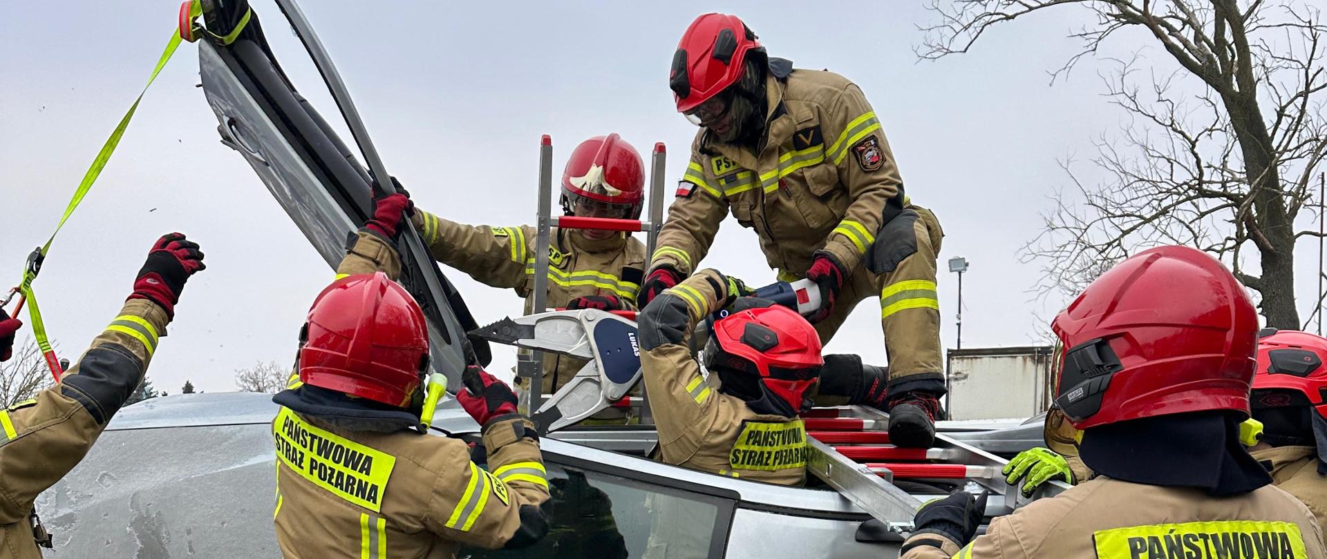 Na zdjęciu widnieją strażacy w takcie ćwiczeń z zakresu ratownictwa technicznego