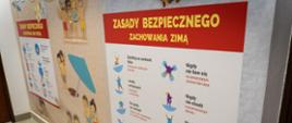 Zdjęcie przedstawia salę edukacyjna "Ognik" w Komendzie Powiatowej Państwowej Straży Pożarnej w Koluszkach. Na zdjęciu widoczna ściana sali, na której zawieszone są plakaty informacyjne np. "zasady bezpiecznego zachowania zimą"