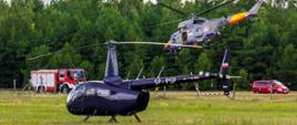 Helikopter przygotowany do startu, na wyznaczonym lądowisku ląduje śmigłowiec Marynarki Wojennej RP. Lądowisko jest zabezpieczone przez samochód gaśniczy.