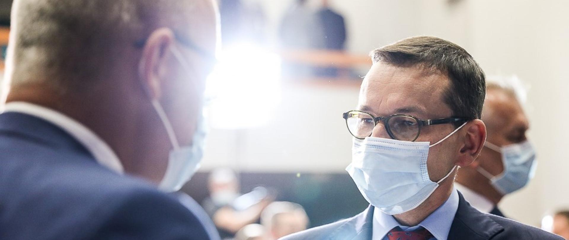 Premier rozmawia z mężczyzną.