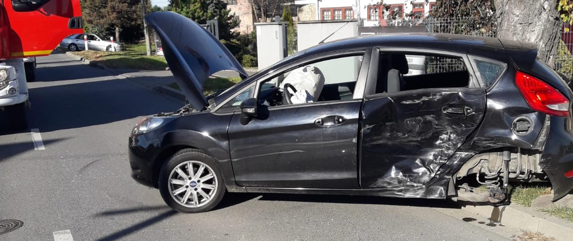 Rozbity samochód osobowy ford w poprzek drogi