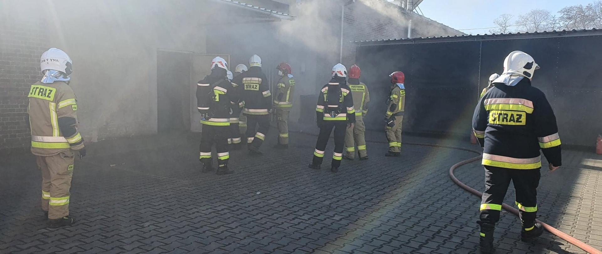 Widać strażaków przed halą produkcyjną