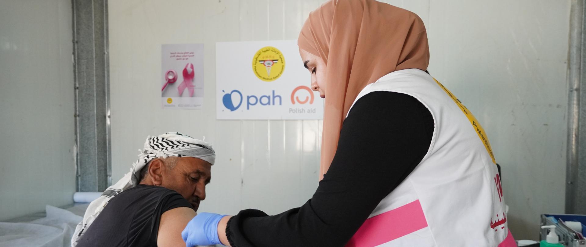 A doctor checks the blood pressure of an elderly man