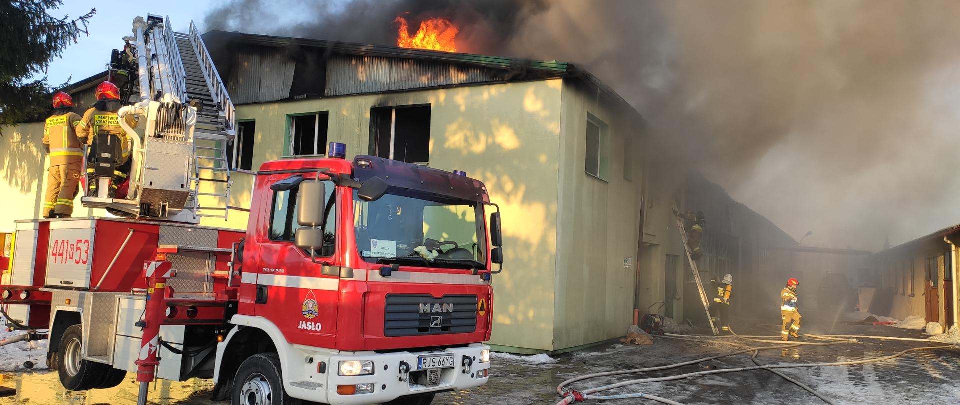 Pożar hali produkcyjnej na ulicy Młynarskiej w Jaśle. Na zdjęciu strażacy gaszący Pożar hali produkcyjnej.