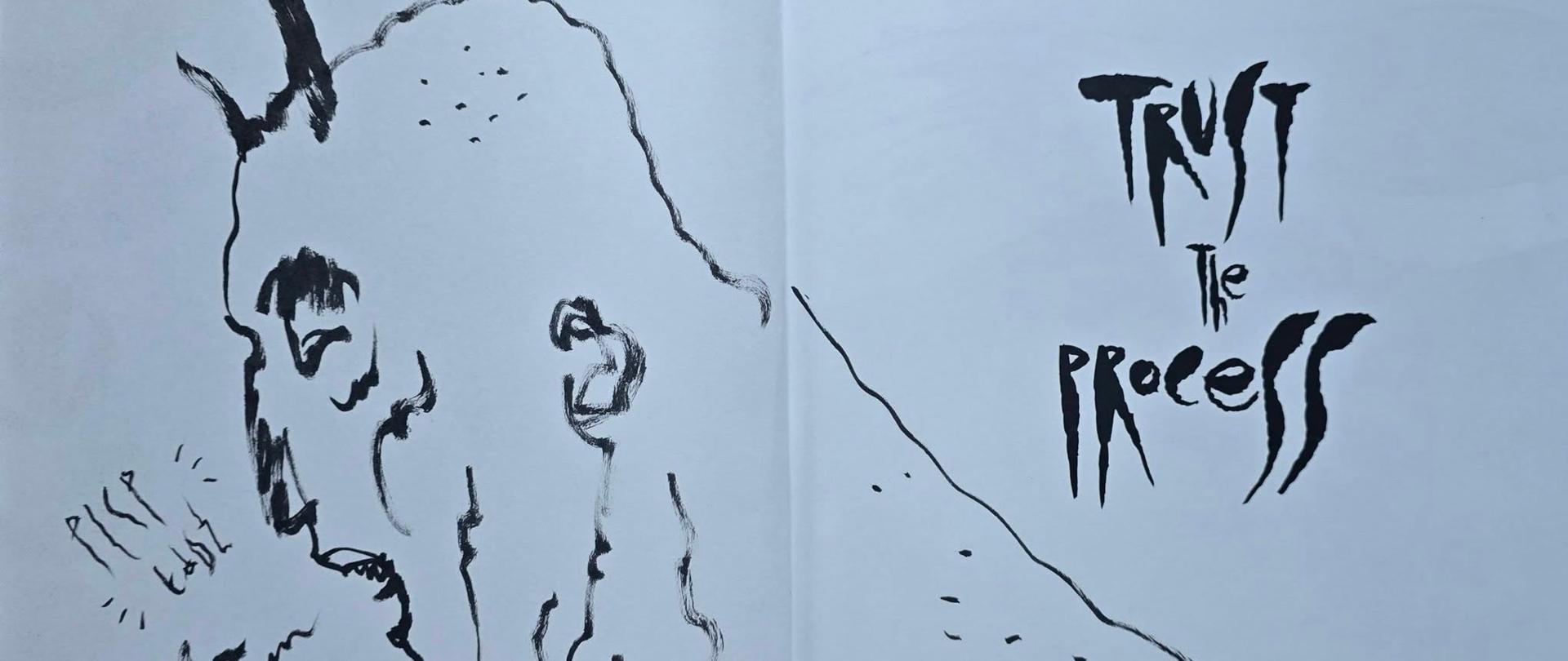 Fragment dedykacji w książce dla PLSP w Łodzi przedstawiający postać z rogami i stylizowanym napisem Trust the Process autorstwa Przemysława Truścińskiego