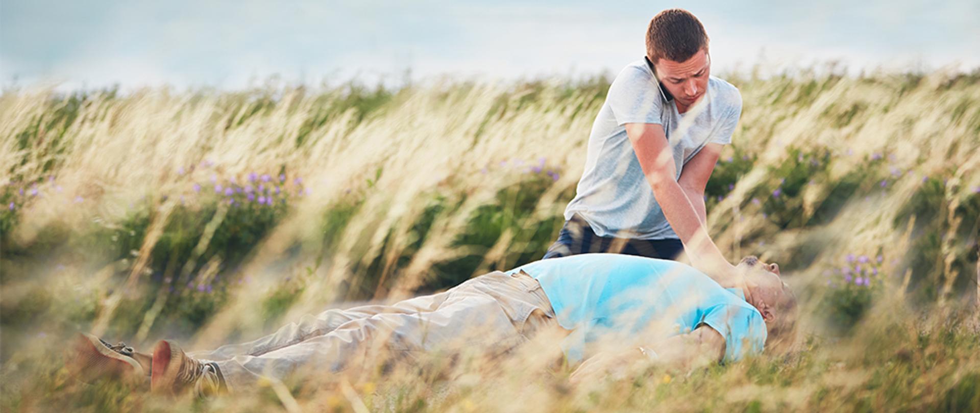 Young man calling for Emergency medical service. Dramatic resuscitation on the rural road. Themes rescue, help and hope.