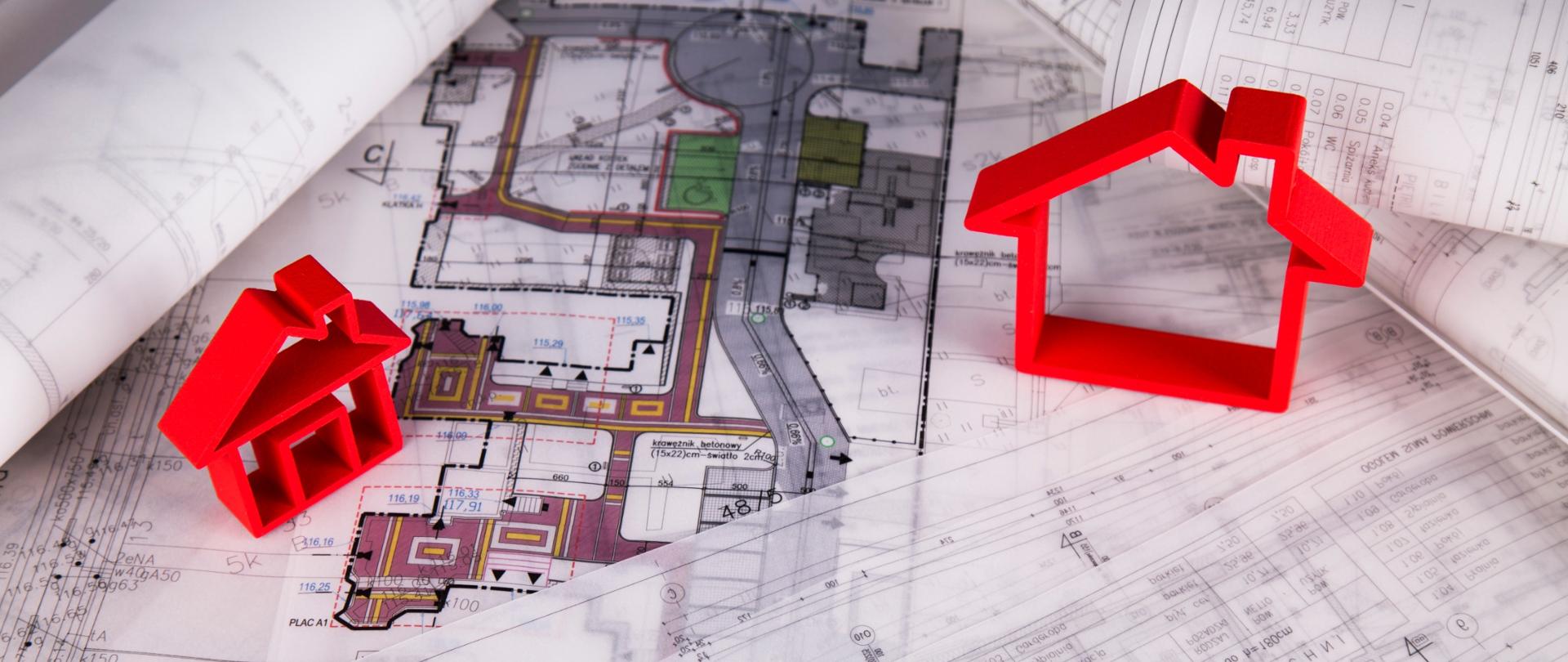 Widok planów budynku na których stoi czerwony zarys domu