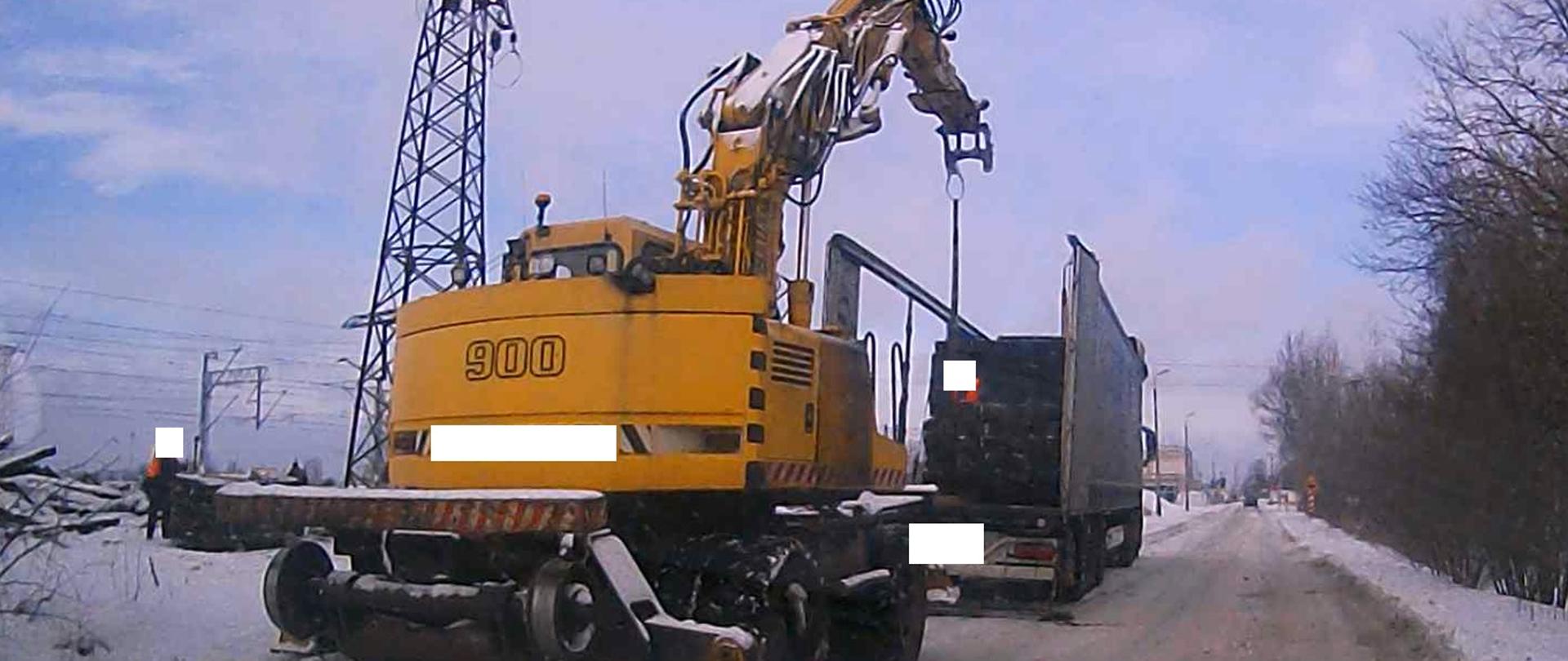 Zima, koparka składująca zużyte podkłady kolejowe w celu ich zutylizowania