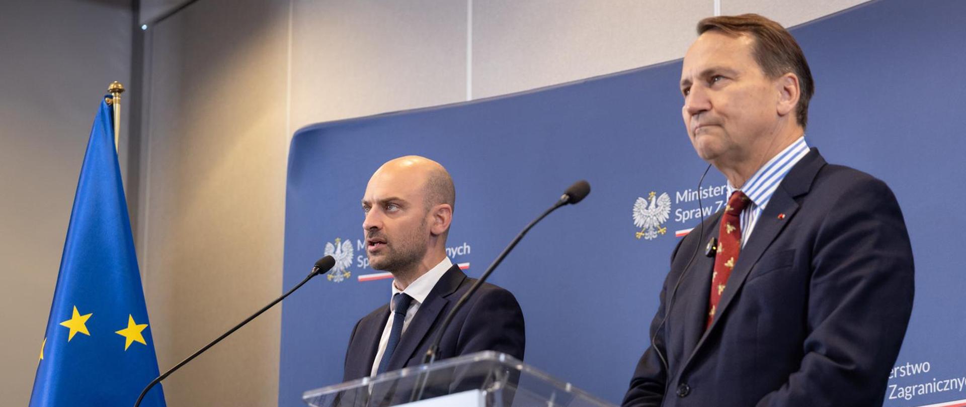 Minister Minister Spraw Zagranicznych Francji Jean-Noel Barrot i Wicepremier, Minister Spraw Zagranicznych Polski Radosław Sikorski stoją przy mównicach podczas wspólnej konferencji prasowej. Na mównicach umieszczono flagi Francji i Polski, a w tle widoczna jest flaga Unii Europejskiej oraz ścianka Ministerstwa Spraw Zagranicznych