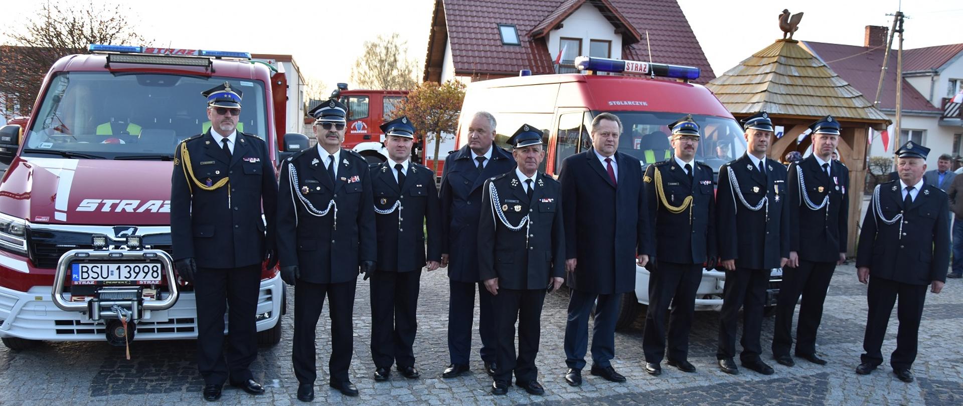 Zdjęcie obrazuje strażaków osoby cywilne i pojazdy pożarnicze