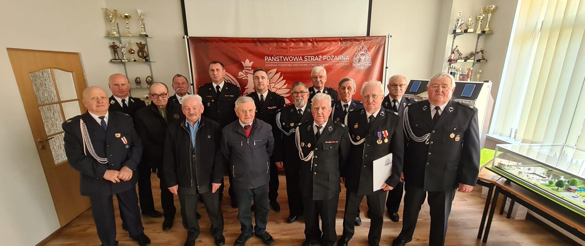 Widać kilku strażaków na zdjęciu grupowym