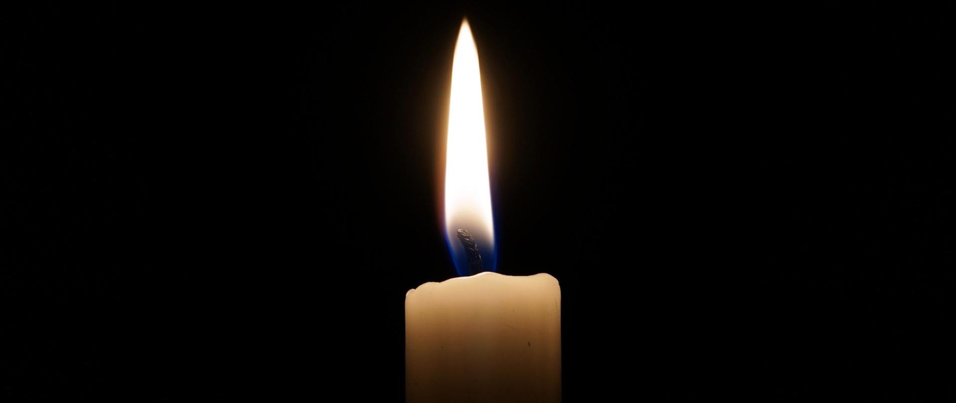 Zdjęcie przedstawia świeczkę jako symbol żałoby po odejściu bliskiej osoby.