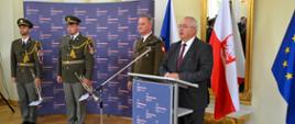 Kierownik WPE Jacek Gajewski wygłasza przemówienie. Obok niego attaché obrony płk. Zbigniew GIerko oraz członkowie sekstetu