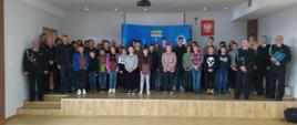 Zdjęcie przedstawia zdjęcie zbiorowe wszystkich uczestników eliminacji powiatowych Ogólnopolskiego Turnieju Wiedzy Pożarniczej pod hasłem "Młodzież zapobiega pożarom".