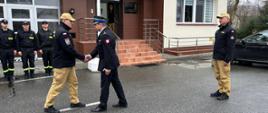 Przywitanie Podkarpackiego Komendanta Wojewódzkiego PSP. w tle zbiórka strażaków i budynek Komendy Powiatowej PSP w Ropczycach