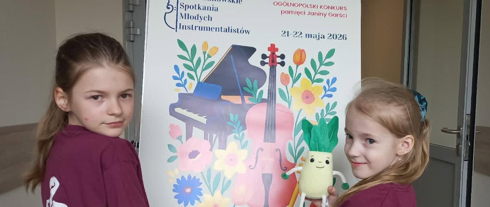 Uczennice na tle baneru konkursu