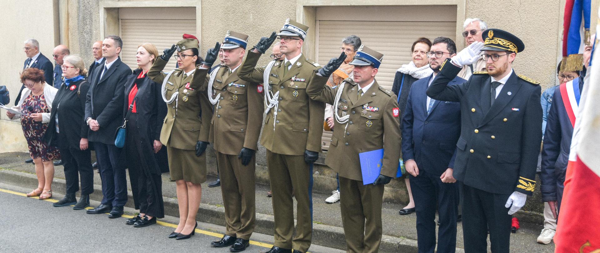 Des représentants des autorités civiles et militaires se tiennent en rang.