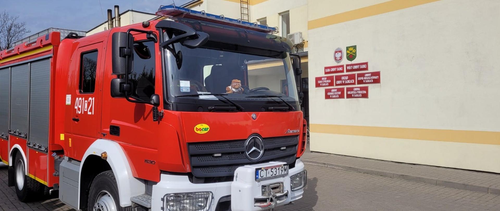 Na zdjęciu samochód gaśniczy na tle Urzędu Gminy w Sadkach.