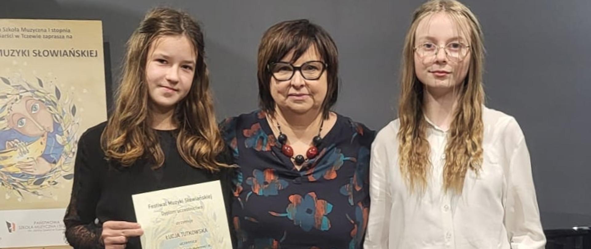 uczennice trzymające dyplomy wraz z nauczycielką