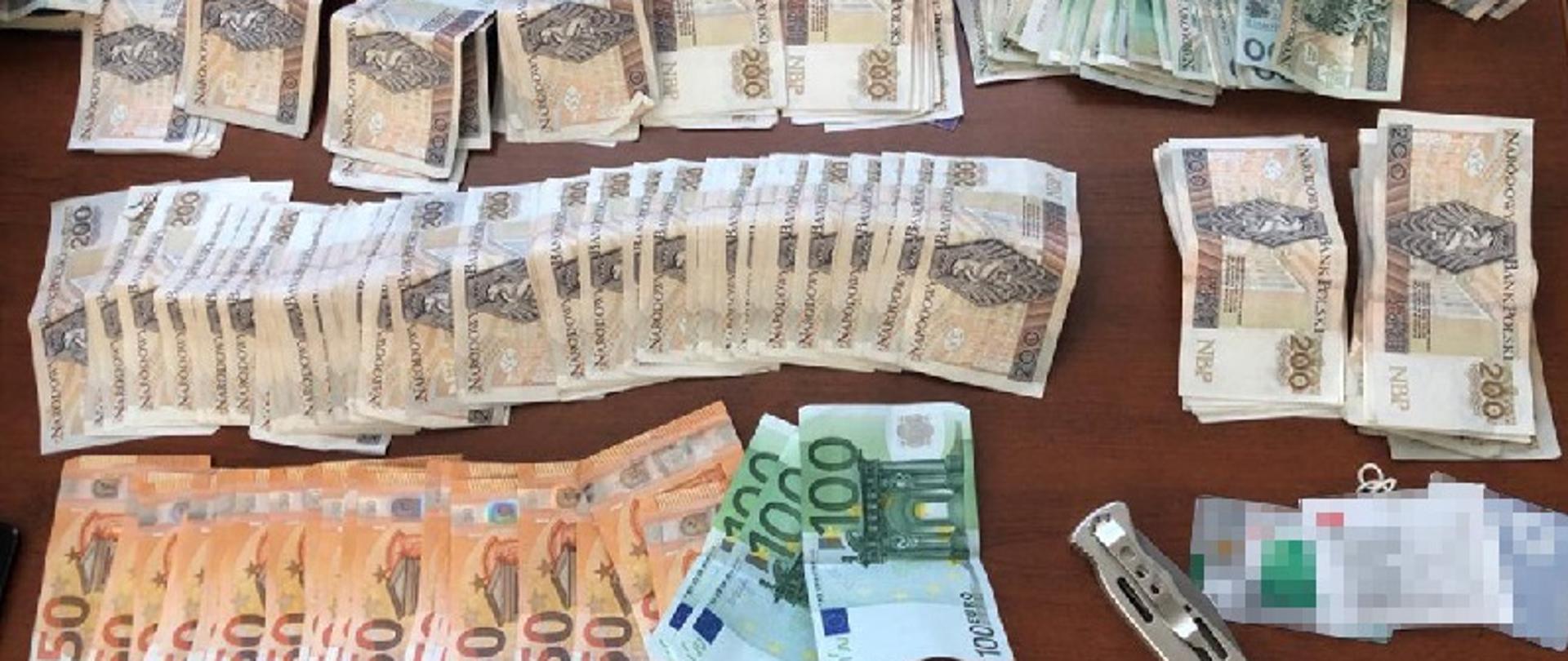 Pieniądze rozłożone euro, złotówki w nominałach: 50, 100, 200.