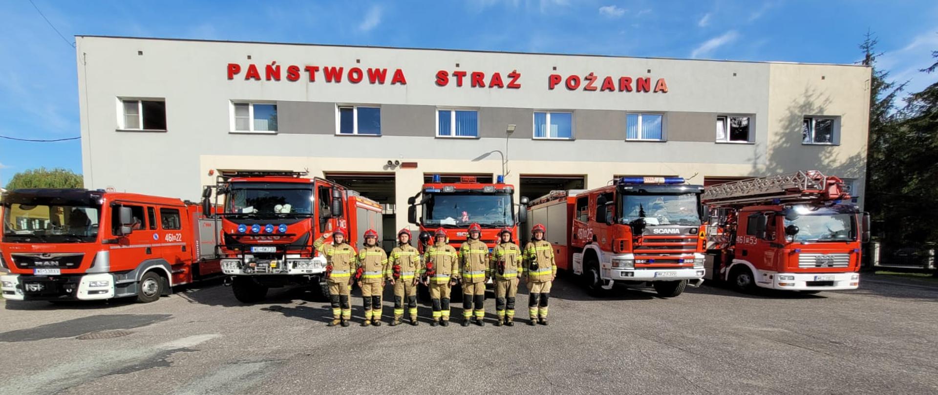 Strażacy PSP oddali hołd ofiarom katastrofy pod Smoleńskiem stojąc na baczność na placu komendy, w tle przed budynkiem komendy wystawione samochody z włączoną sygnalizacją świetlną i dzwiękową