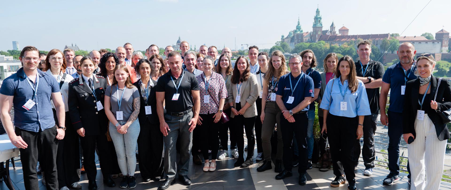 Zdjęcie uczestników wydarzenia FINEX Workshop 2025 na tle Zamku Królewskiego na Wawelu.