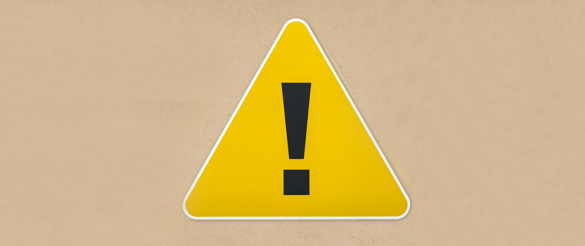 Yellow triangle warning sign icon isolated