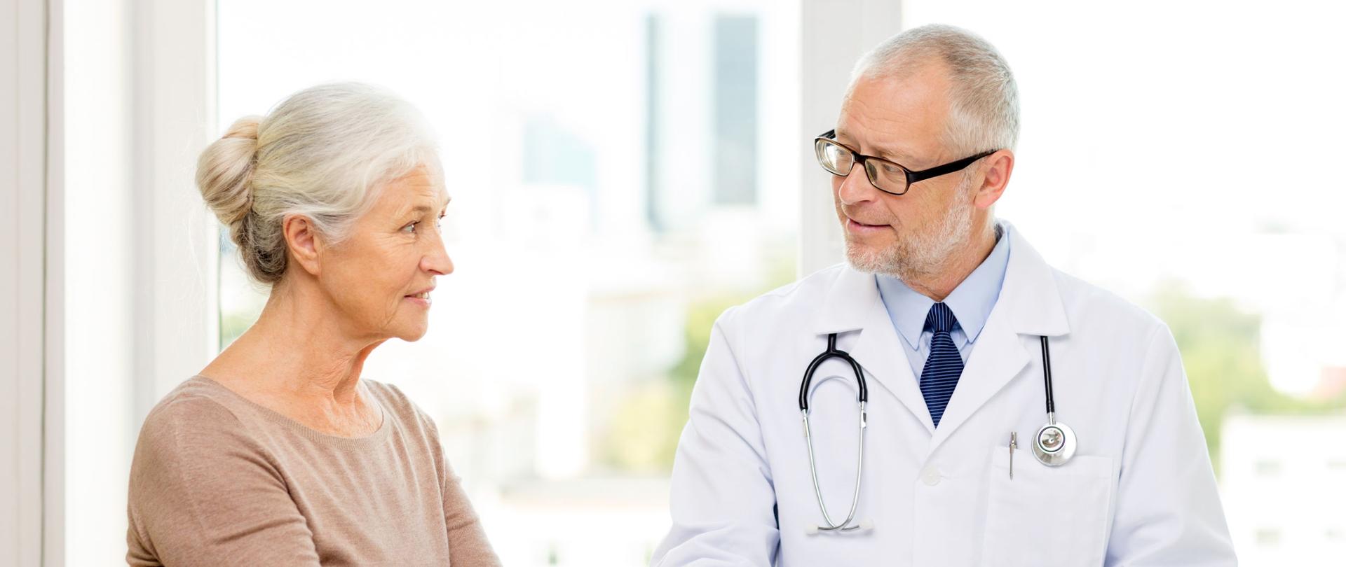 medicine, age, health care and people concept - smiling senior woman and doctor meeting in medical office