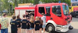 Dzieci tyłem oglądające prezentacje samochodu pożarniczego