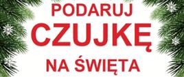 Plakat obramowany gałązkami świerku z napisem: "Podaruj czujkę na Święta", pod którym znajduje się czujka przepasana wstążką a pod nią napis " prezent który może uratować życie. Na dole logo PSP z opisem Komenda Powiatowa Państwowej Straży Pożarnej w Kartuzach.
